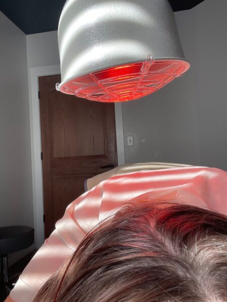 LED red light therapy lamp above scalp