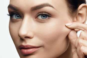 Skincare close-up: woman touching cheek