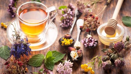 Cup of herbal tea with honey and herbs